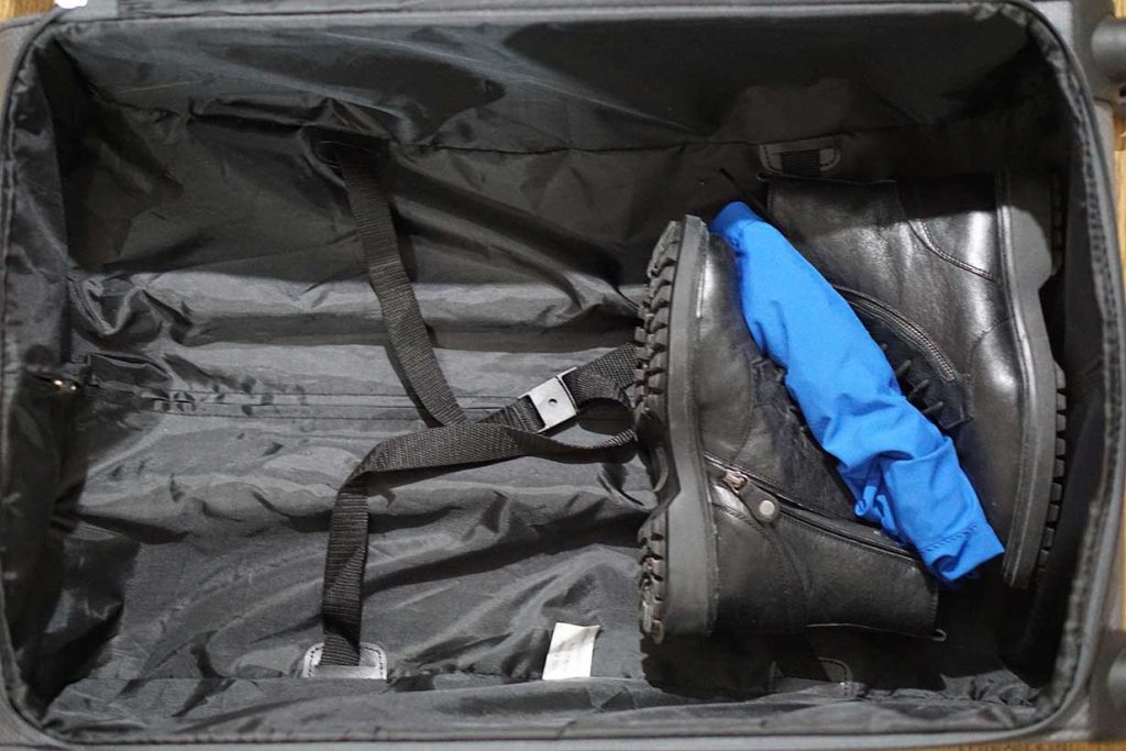 packing boots in a suitcase