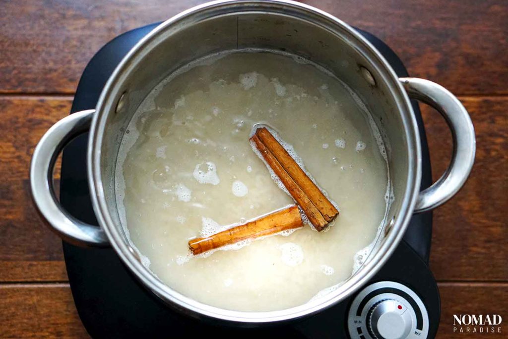 Arroz con leche step by step (adding the rice and cinnamon sticks)