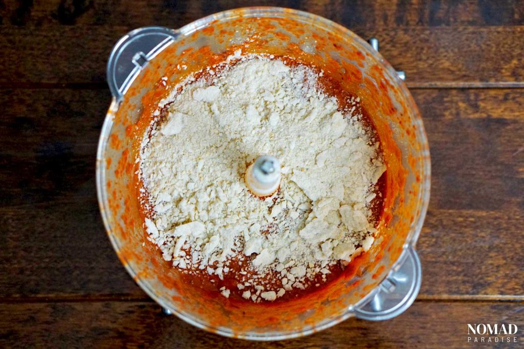 Muhammara recipe step by step (peeled roasted peppers, garlic, tomato paste with spices, pomegranate molasses, and galic in the food processor).