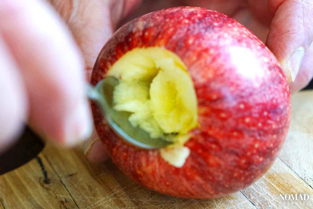 Removing the core of the apple with a spoon for baked apples.