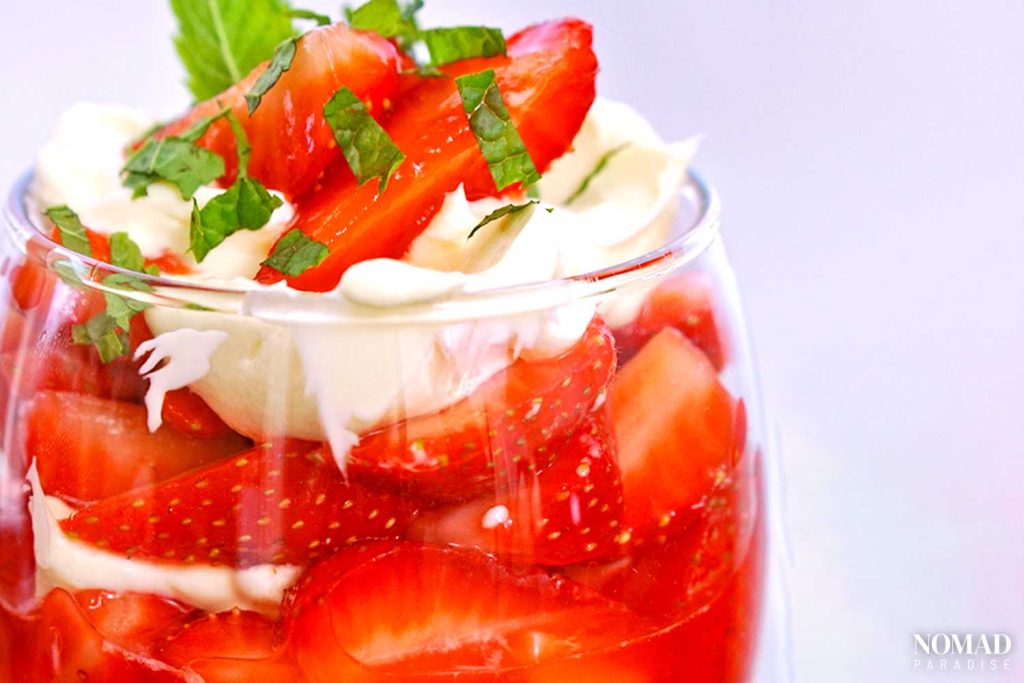 Strawberries and cream in a glass.