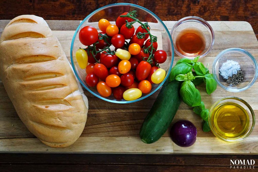 Panzanella salad recipe ingredients on a wooden board