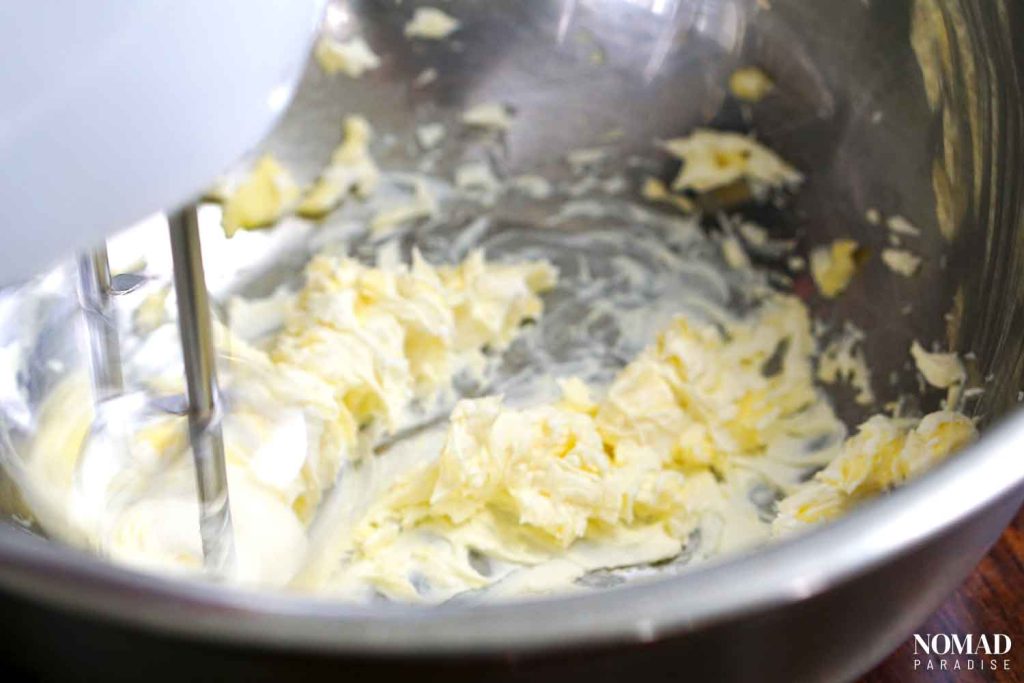 Irish potato candy step by step (mixing softened butter, cream cheese and vanilla in a mixing bowl with a hand mixer).