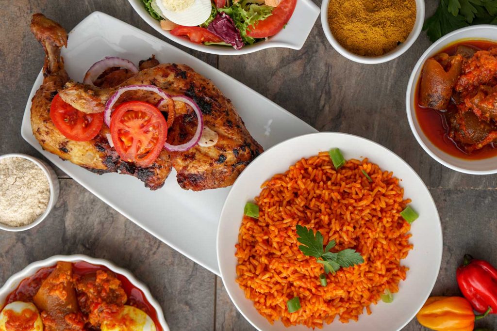 Jollof Rice with an assortment of dishes on the table