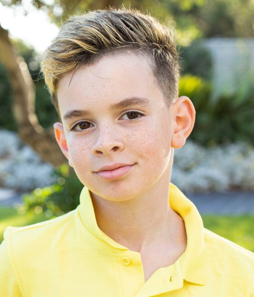 boys long top with short sides haircut and blonde highlights