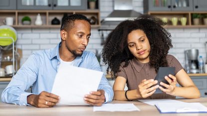 A couple considers looking at financial paperwork for an IRA.