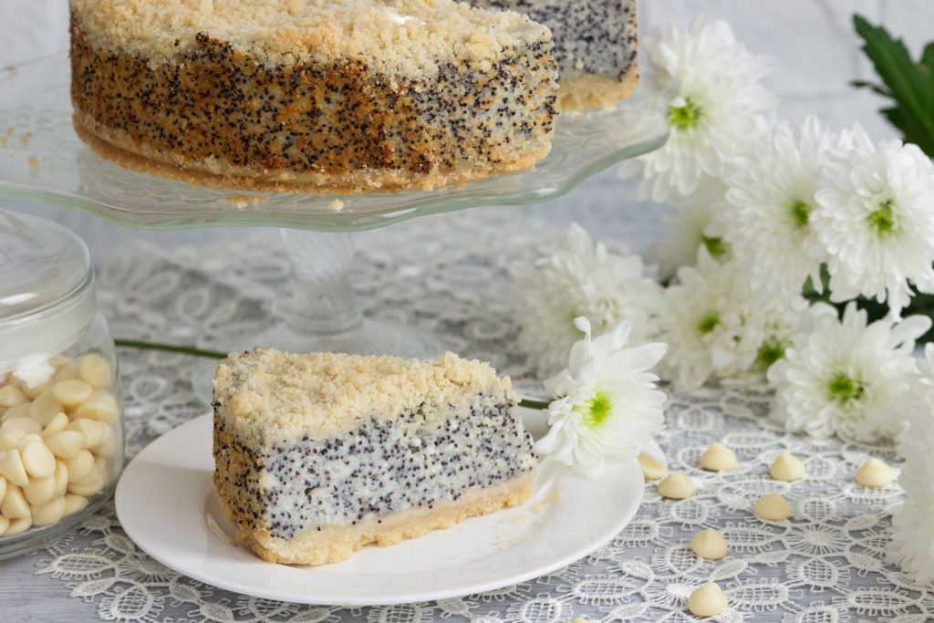 Poppyseed Cake slice and cake in the background.