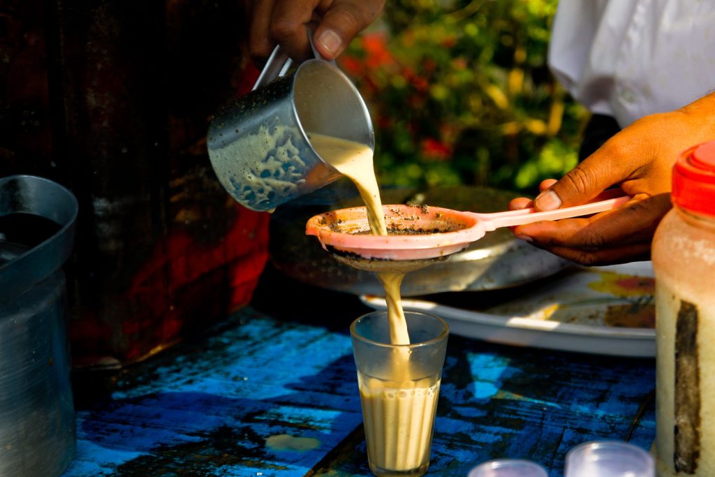 Street vendor pouring chai