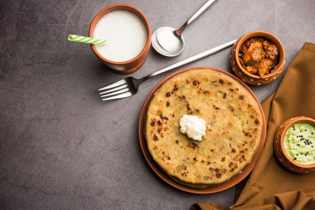 Aloo parathas with butter and chutney on theside.