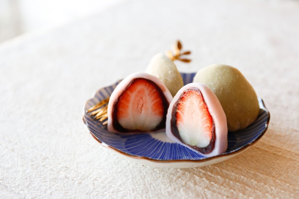 Strawberry Daifuku (Mochi Balls Filled with Sweet Bean Paste) on a small plate.