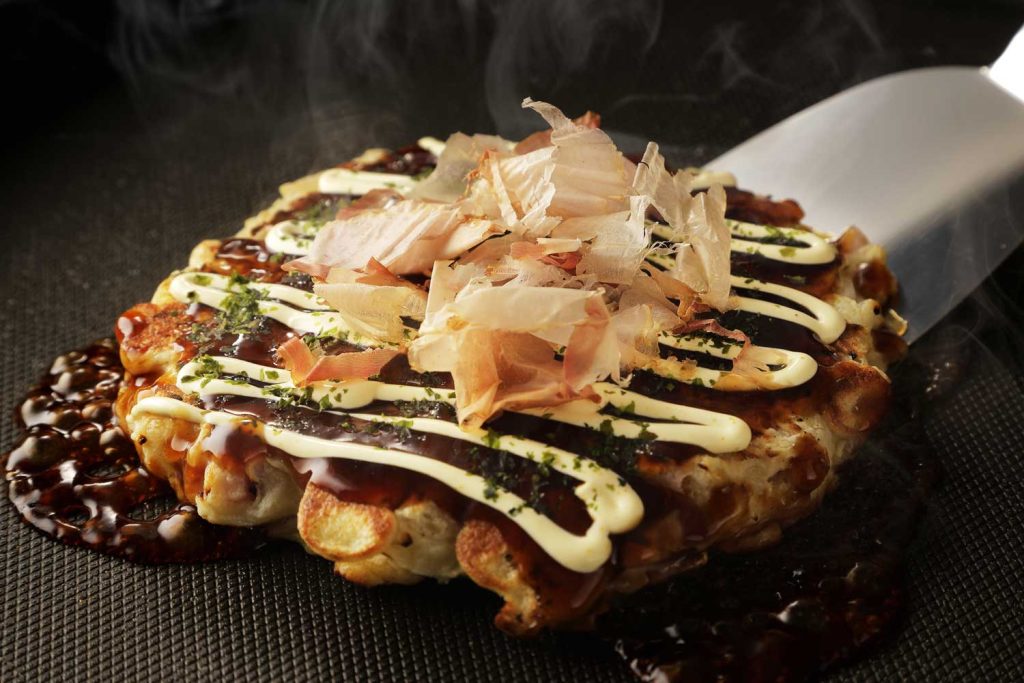 Okonomiyaki (a Japanese savory pancake) ready to be served.