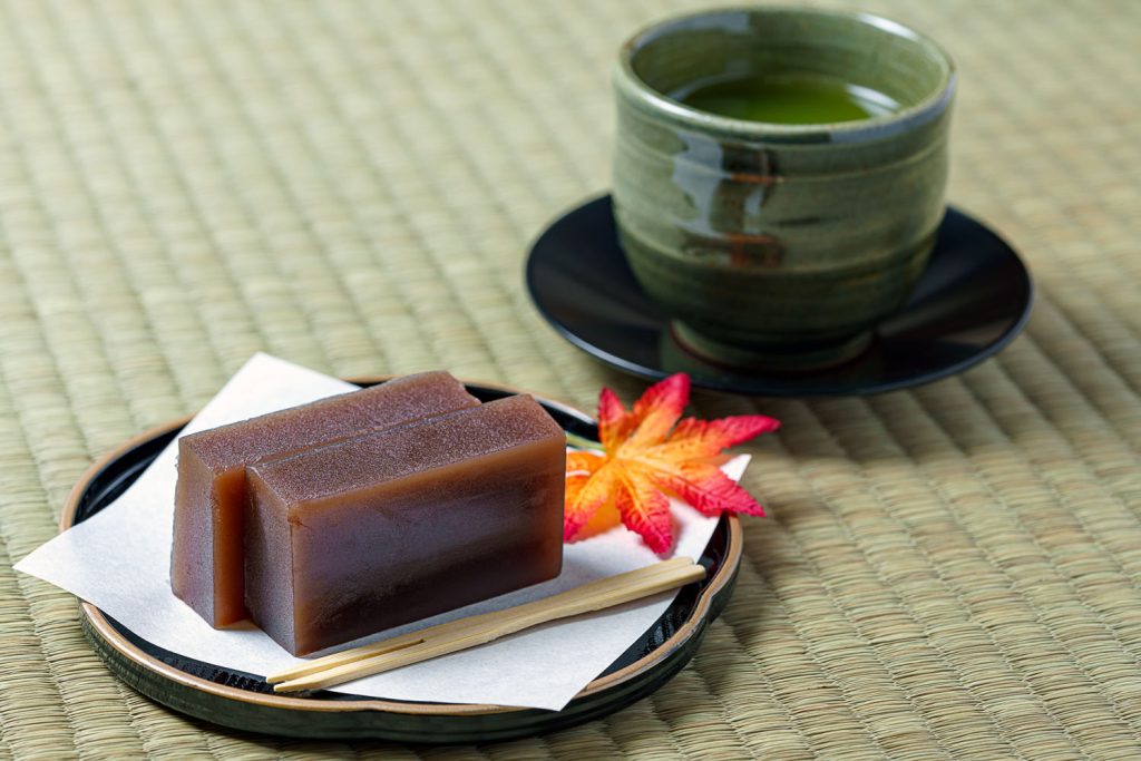 Two blocks of Mizu yōkan (sweet red bean paste) with a cup of Japanese tea.
