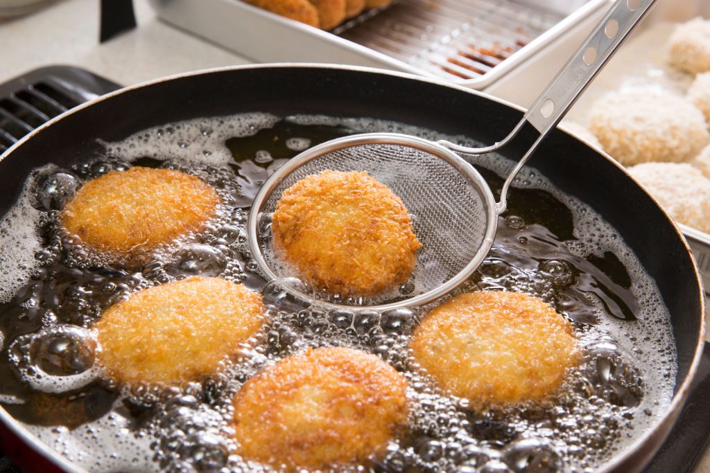 Frying croquettes in a big pan.
