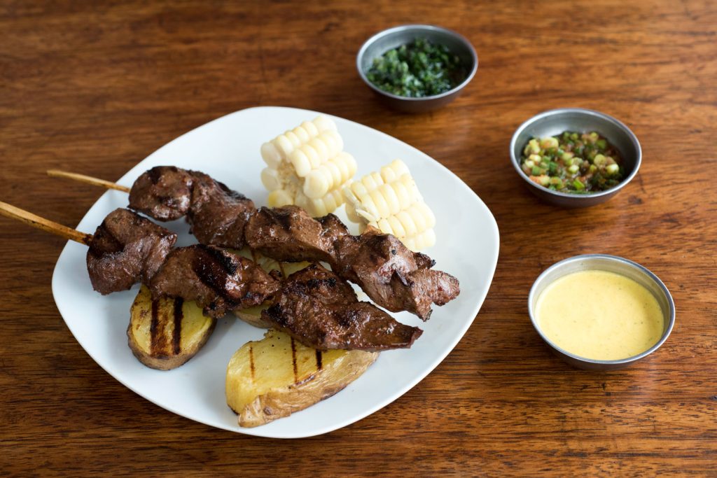 Anticuchos with dipping sauces.