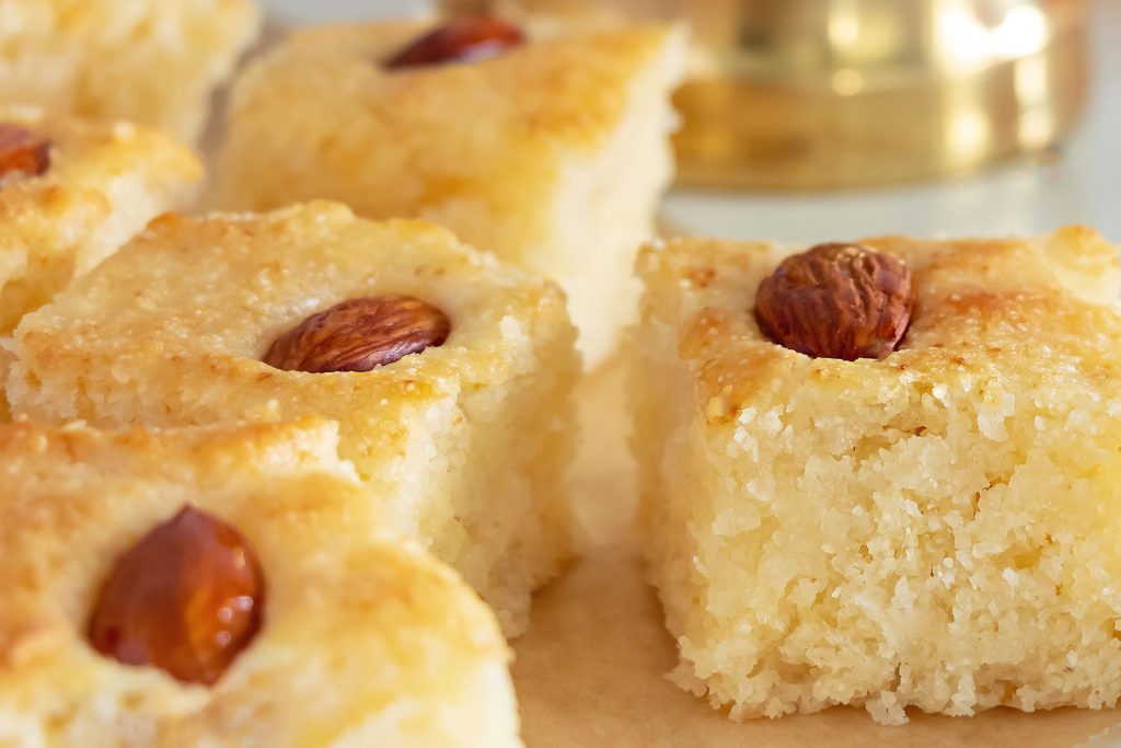 Namoura or basbousa individual servings, topped with almonds.