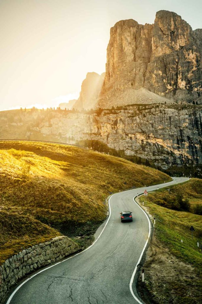 Staycation idea: road trip, a car on a winding road.