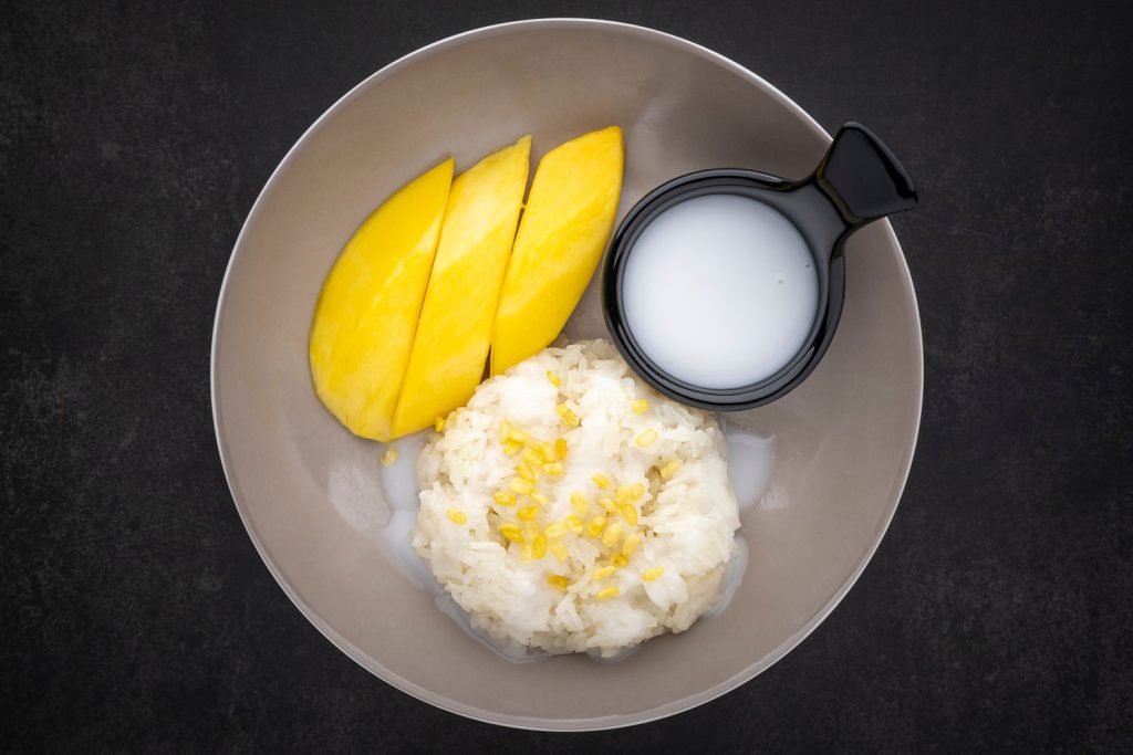 Mango sticky rice with coconut cream and yellow mung beans.