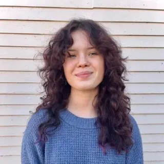 curtain bangs with curly brunette hair
