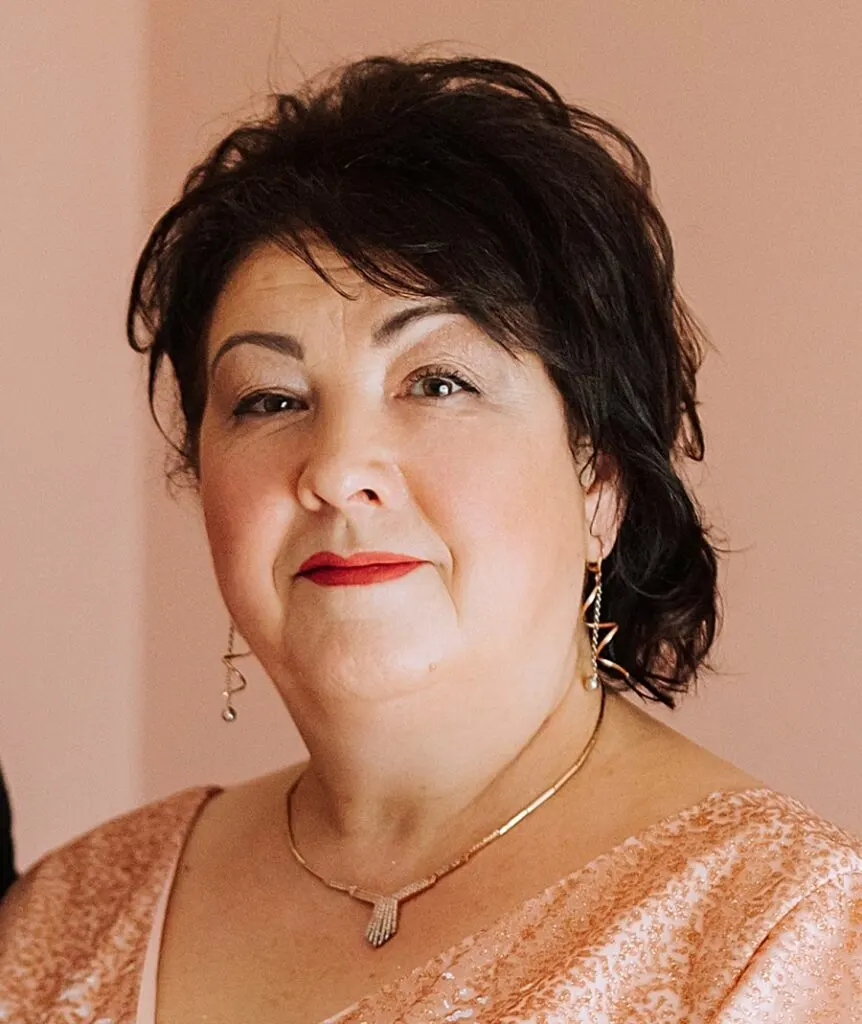 mother of groom with loose updo hairstyle