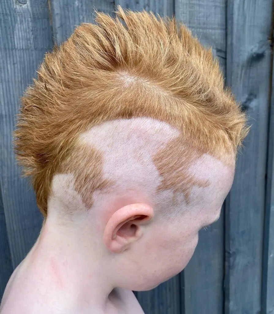 redhead boy mohawk with lizard leg design