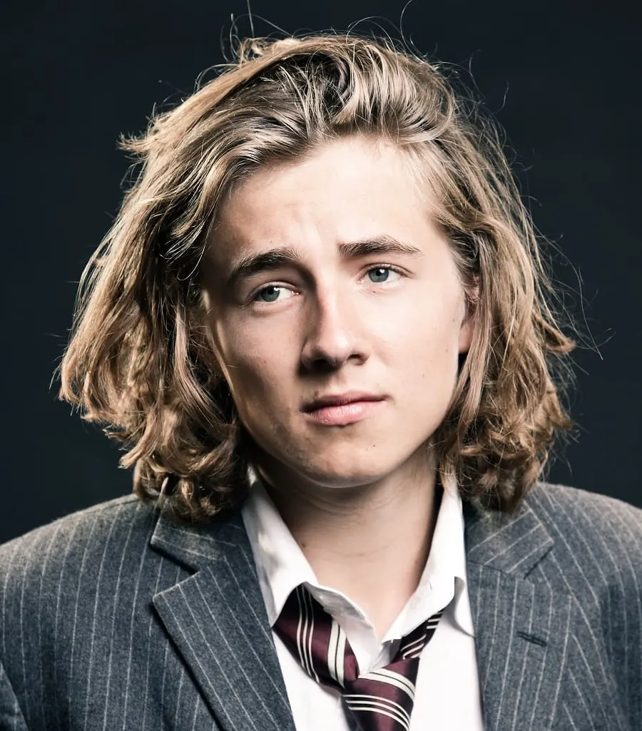 side swept wavy long hairstyle for men